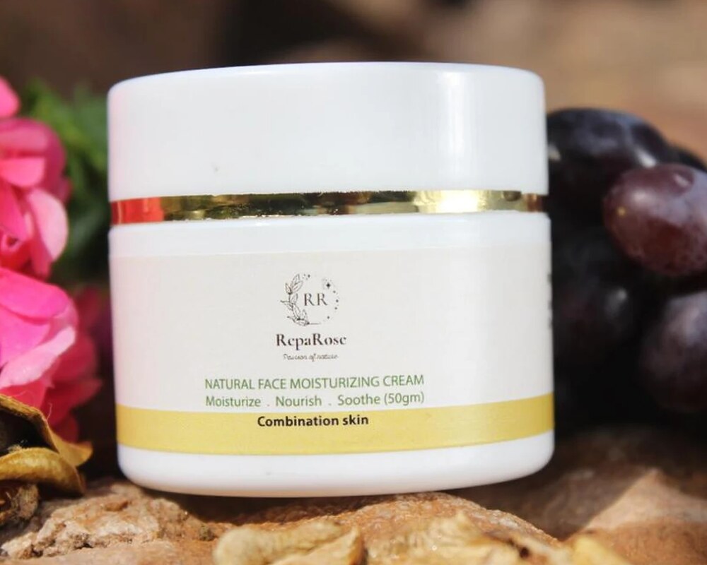 RepaRose face cream on a stone among garden flowers
